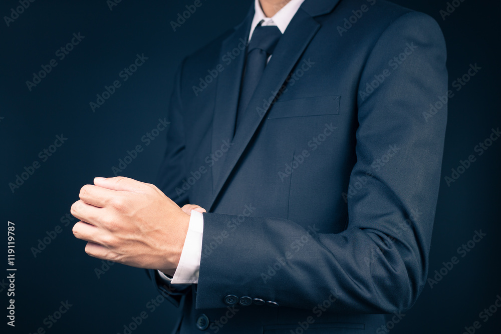 Businessman Fixing Cufflinks his Suit