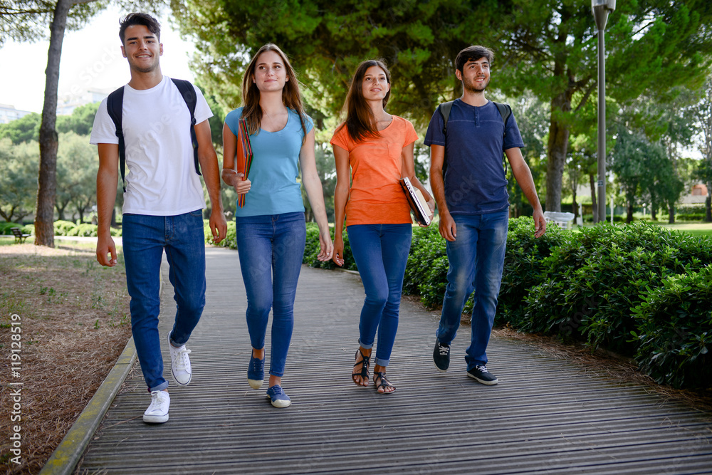 group of young students walking together in a high school university campus