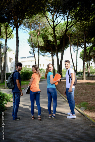 group of young students walking together in a high school university campus