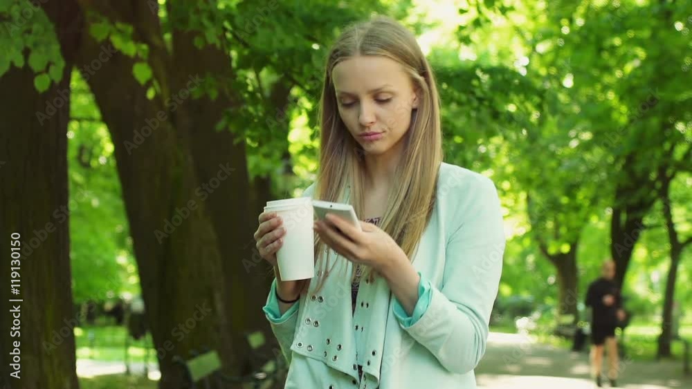 Irritated girl texting sms on smartphone while waiting for someone in the park
Irritated girl texting sms on smartphone while waiting for someone in the park