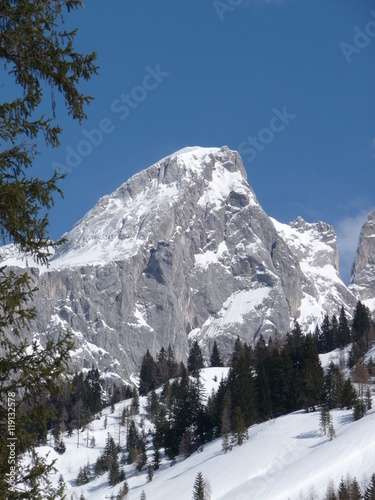 Snow covered mountain peak and forest above the Austrian alpine town of Filzmoos