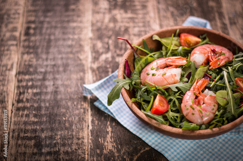 Green salad with shrimps on wooden table.healthy food