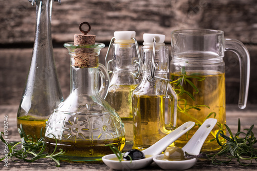 Oils on vintage wooden background . healthy food