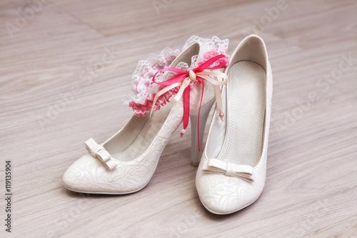 Stylish white female wedding footwear. Bridal shoes, close-up