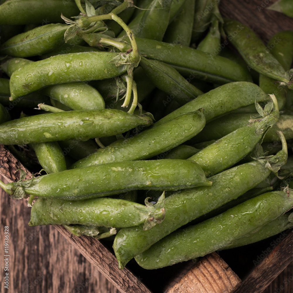 pods of green peas on a wooden table, rustic style,healthy food pods of green peas on a wooden table, rustic style,healthy food
