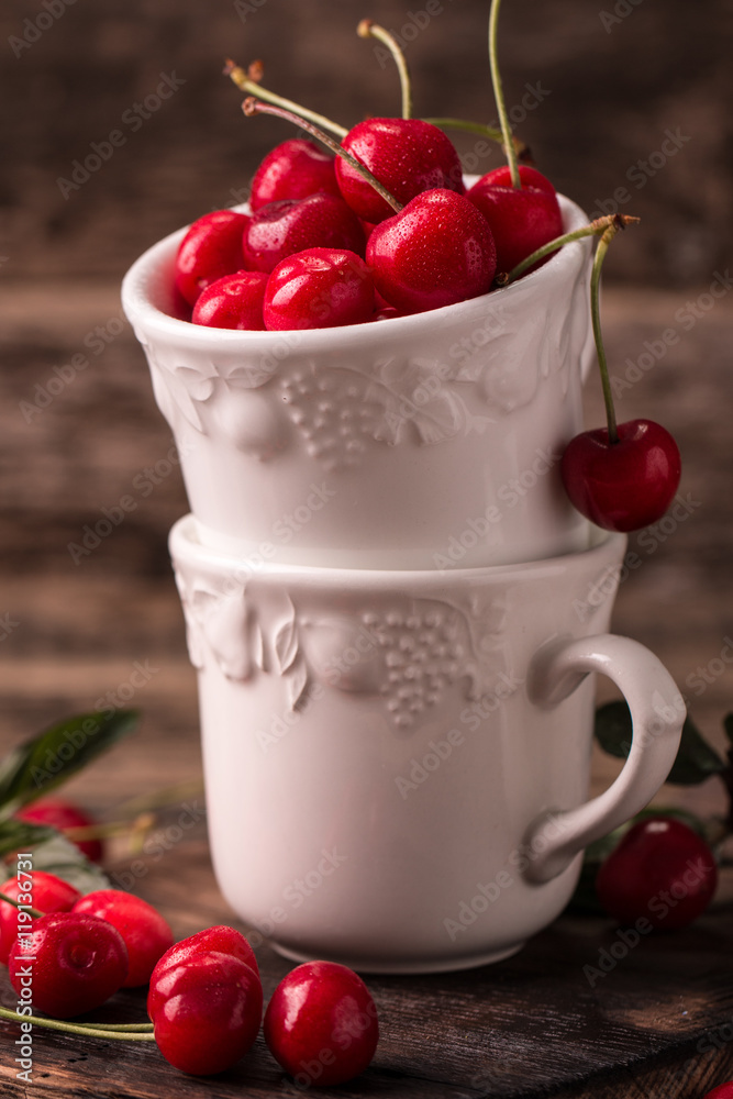 Ripe Cherries on wooden table with water drops Ripe Cherries on wooden table with water drops
