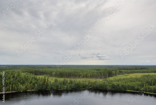 A view from high. An image of a Finnish landscape from the top of the hill. Dramatic clouds are in the sky.