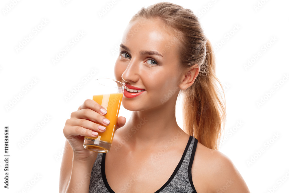 Beautiful sportive girl holding glass with juice over white background. Beautiful sportive girl holding glass with juice over white background.