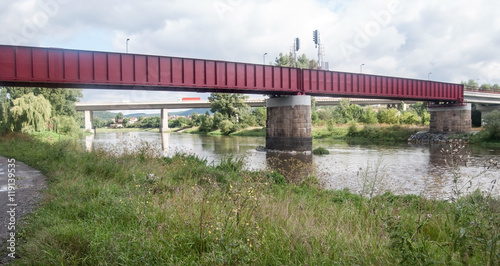 Berounka river with railway bridge and road bridge on the background in Beroun city in Central Bohemia photo