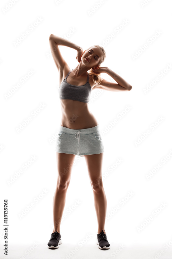 Beautiful sportive girl training over white background. Beautiful sportive girl training over white background.
