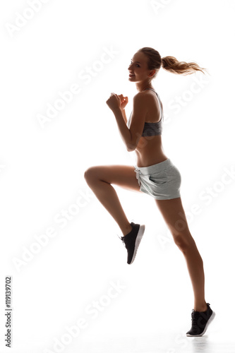 Fototapeta Naklejka Na Ścianę i Meble -  Beautiful sportive girl training over white background.