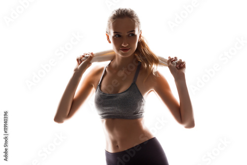 Beautiful sportive girl holding towel, posing over white background. © Cookie Studio