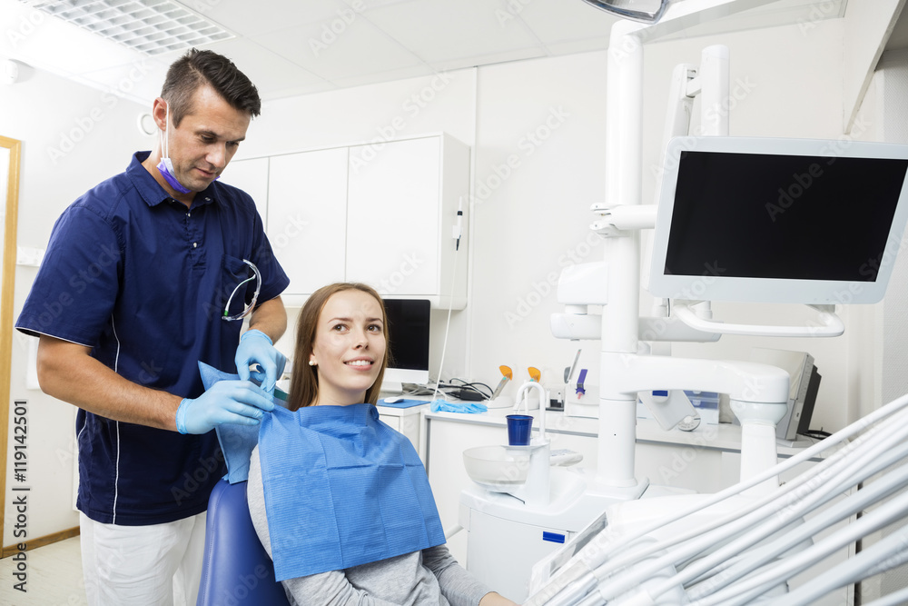 Dentist Preparing Female Patient For Checkup Dentist Preparing Female Patient For Checkup
