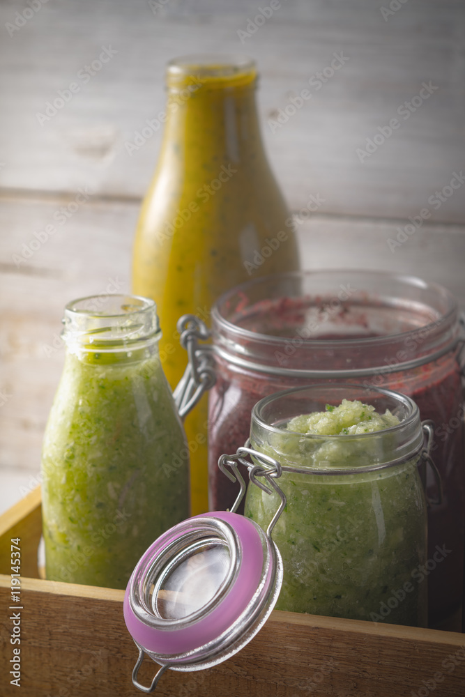 Jars with different smoothies in the wooden box vertical Jars with different smoothies in the wooden box vertical