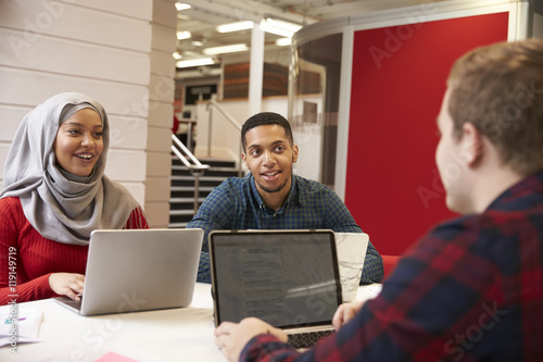 Group Of University Students Collaborating On Project