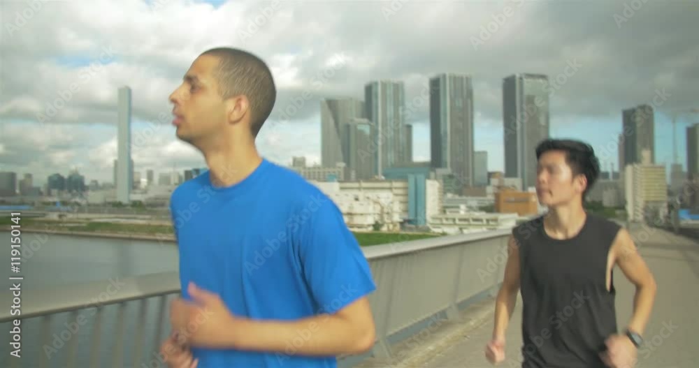 Japanese and International man running together on bridge in Tokyo Japan steadicam shot Japanese and International man running together on bridge in Tokyo Japan steadicam shot