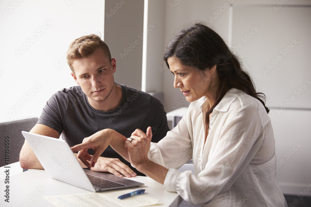Male University Student Working One To One With Tutor Male University Student Working One To One With Tutor