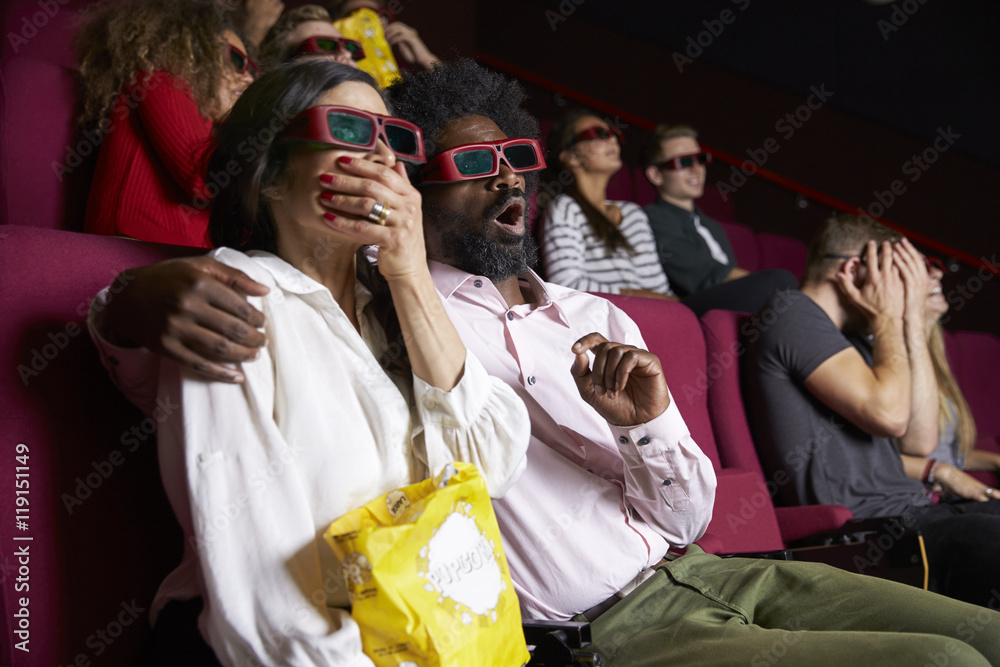 Fototapeta premium Couple In Cinema Wearing 3D Glasses Watching Comedy Film