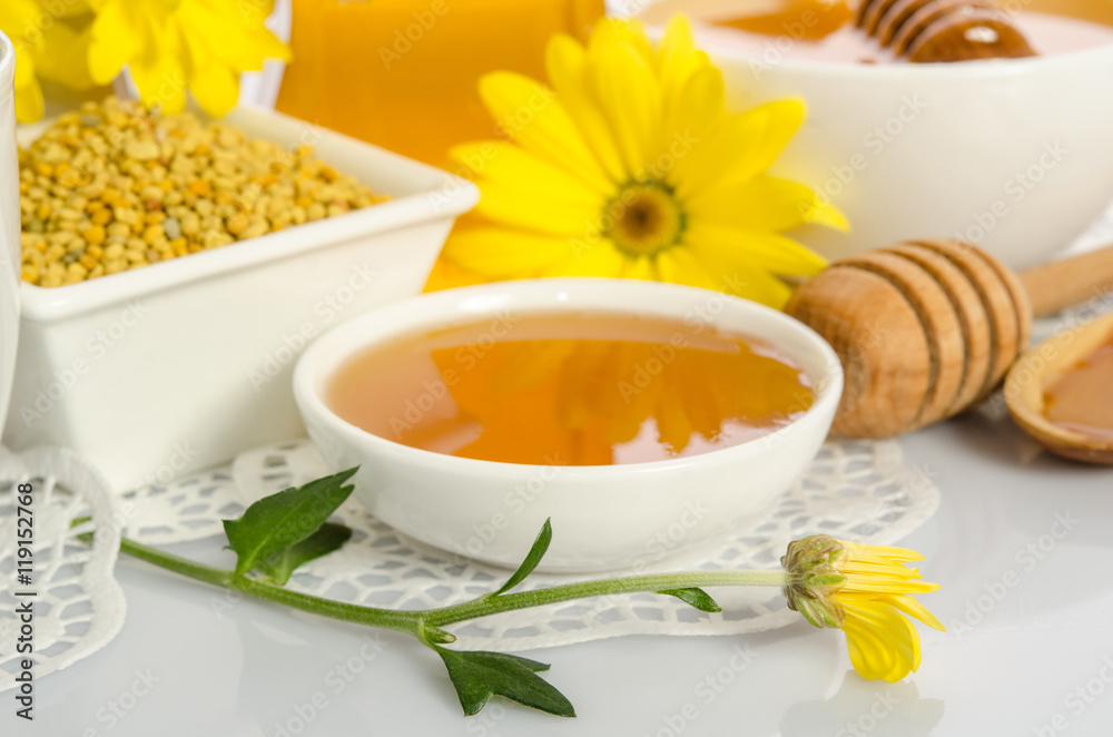 The bowl of honey, bowl with pollen and yellow flower isolate The bowl of honey, bowl with pollen and yellow flower isolate