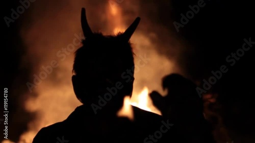 silhouette devil hell on the background of fire photo
