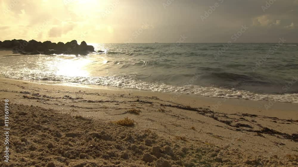 Tranquil waves on an empty beach with white sand at sunrise (or sunset) travel video background, shot in Miami Beach, Florida Tranquil waves on an empty beach with white sand at sunrise (or sunset) travel video background, shot in Miami Beach, Florida