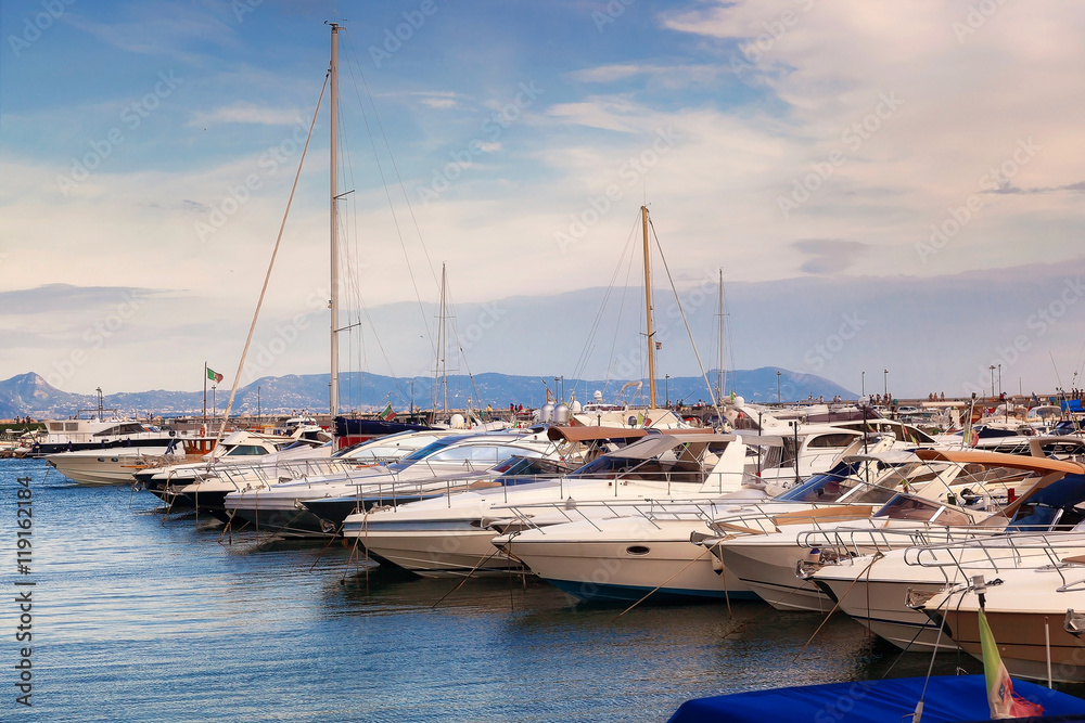 Sailboats and motorboats moored in the marina