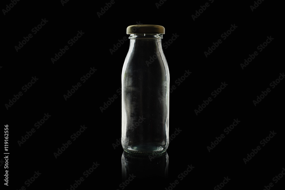 empty glass bottle with cap isolated on black background empty glass bottle with cap isolated on black background