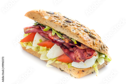 Bacon baguette with egg, tomato and lettuce. Isolated on white background.