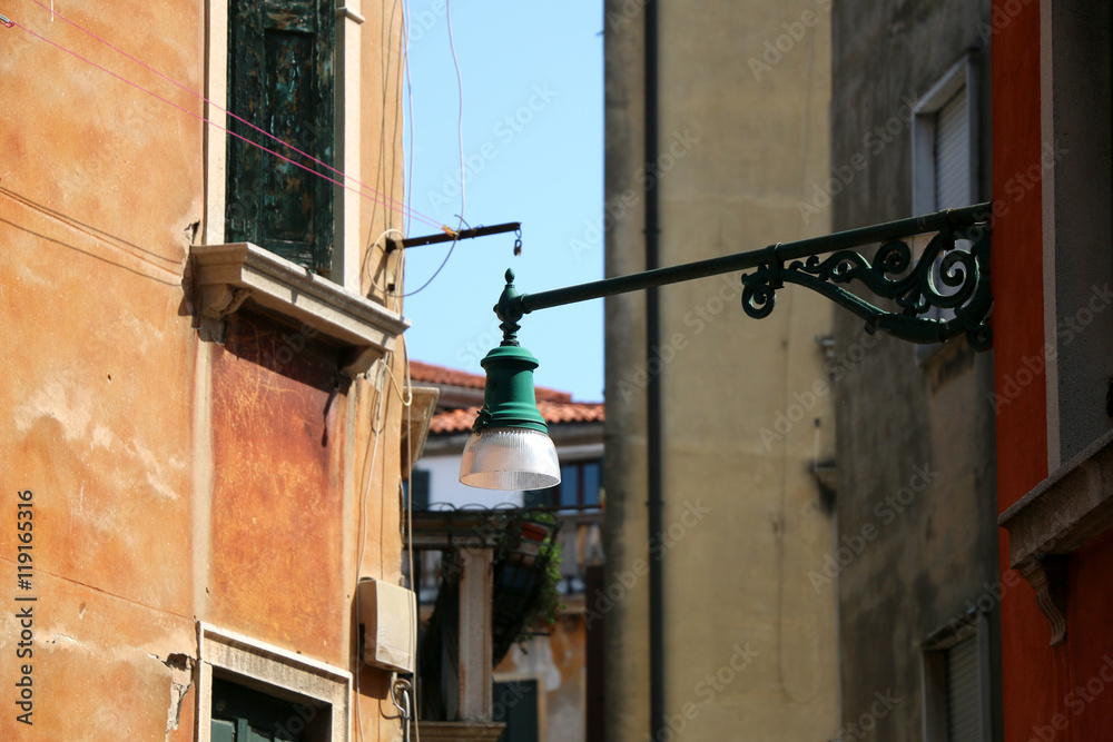 Traditional lamp on the picturesque street in Venice, Italy. Selective focus.