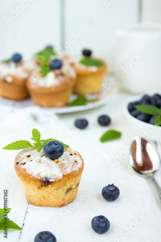 Cupcake with blueberries and mint.