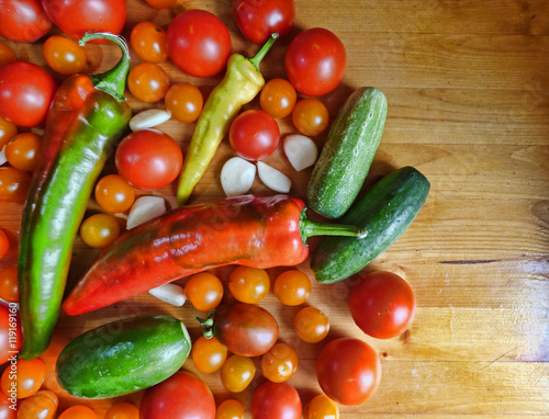 Tomatoes, cherry, cucumbers, garlic and peppers - vegetable background