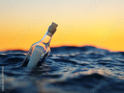 Glass bottle with letter in the sea