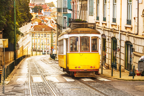 Classic yellow tram on a street in Lisbon, Portugal