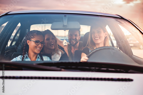 Group of friends having fun in the car