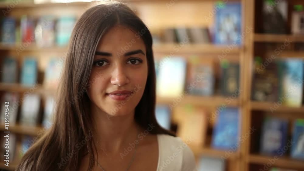 portrait of smiling beautiful woman in library portrait of smiling beautiful woman in library