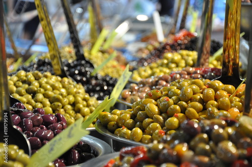 Marinated olives on street market closeup with selective focus