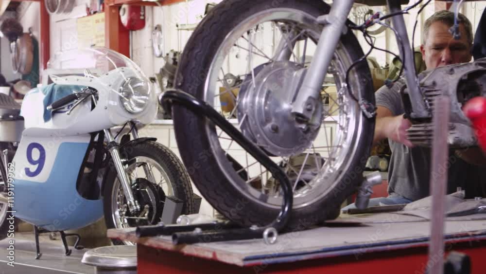 Man working on motorcycle Man working on motorcycle