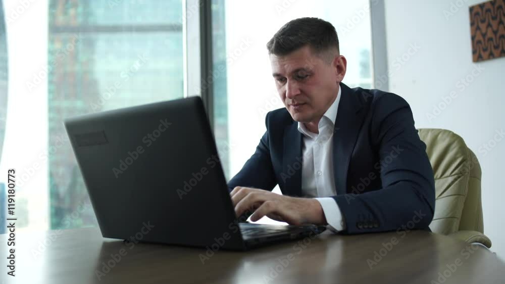 businessman in office correspondence, the laptop recognizes the bankruptcy news is evil as businessman in office correspondence, the laptop recognizes the bankruptcy news is evil as