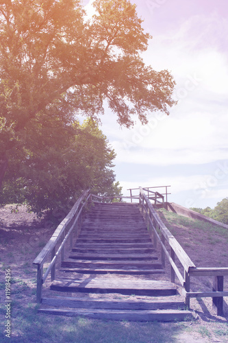 Old wood stairs in wood with blue sky background, filtered color