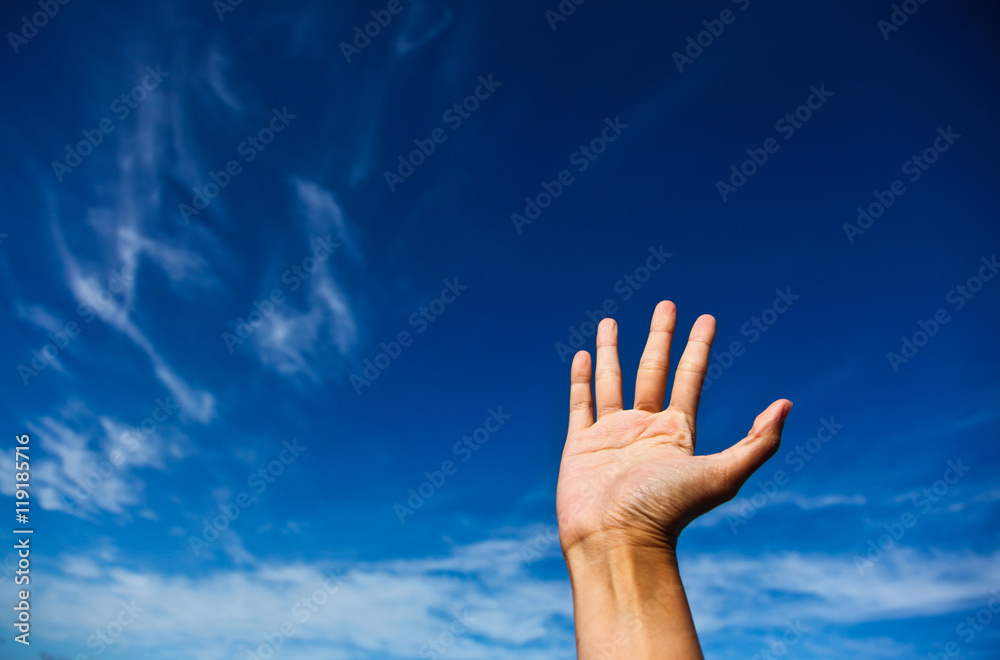 Outstretched arm against a blue sky. Concept greeting.