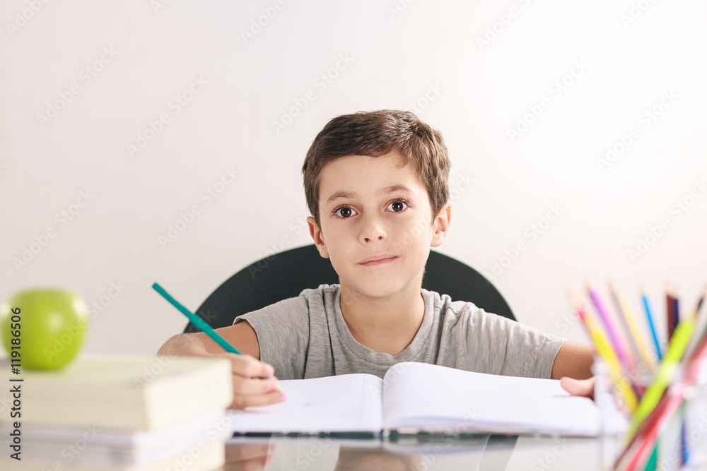 Candid portrait of a boy doing his homework and studying at home Candid portrait of a boy doing his homework and studying at home