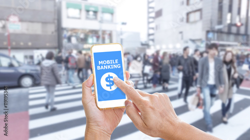 Hands holding smartphone with Mobile Banking application on scre