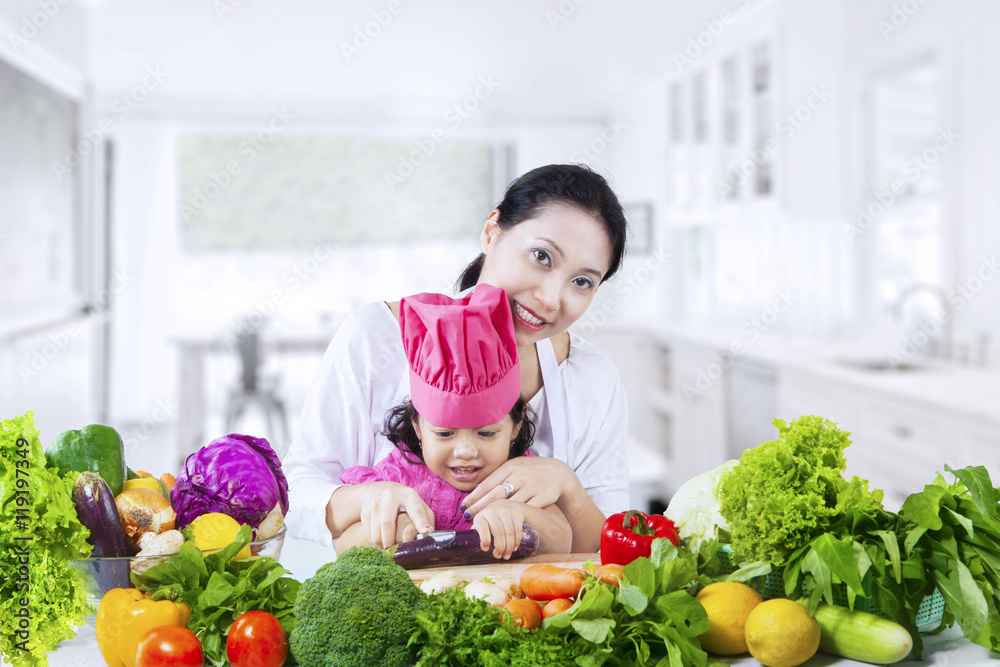 Pretty girl learns to prepare vegetables Pretty girl learns to prepare vegetables
