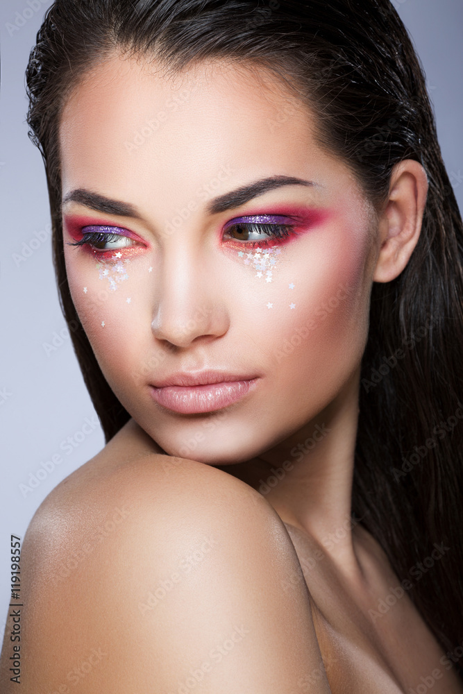 Model with little glittering stars on face Model with little glittering stars on face