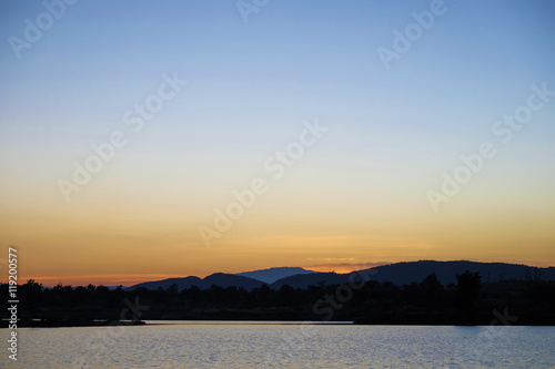 Beautiful sky, lake and hill at sunset