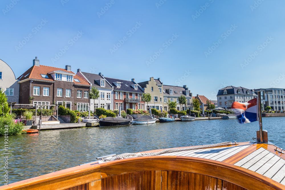 Village landscape as seen from the river Vecht of  the old dutch village Maarssen with characteristic stepped gable houses. 