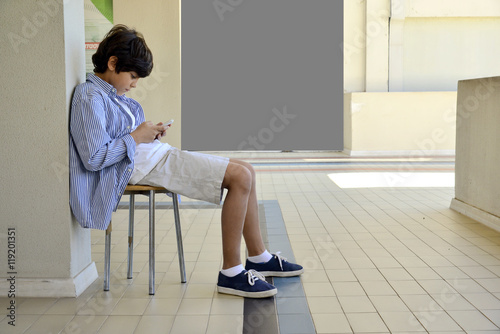 Boy playing with cell phones