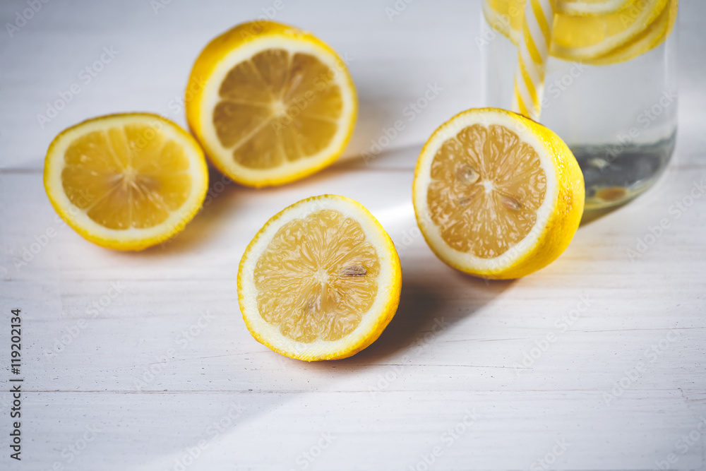 Yellow bottle of lemonade with lemons and straw. Yellow bottle of lemonade with lemons and straw.