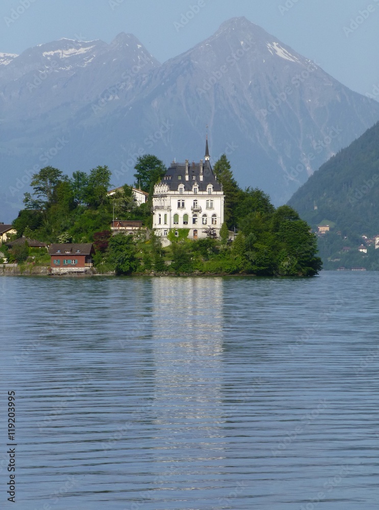View across Brienzersee Lake, Switzerland towards Iseltwald castle and Niesen mountain beyond View across Brienzersee Lake, Switzerland towards Iseltwald castle and Niesen mountain beyond