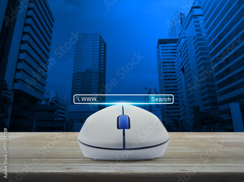 Wireless computer mouse with search www button on wooden table o